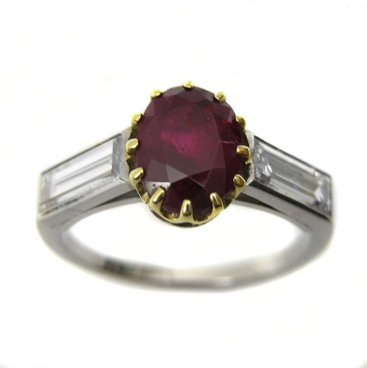 Oval ruby single stone centre and baguette diamond ring